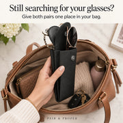Hand lifting one open double eyeglass case containing two pairs from a handbag.
