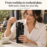 Woman at a cafe taking glasses from an open case while sunglasses remain in the other compartment.